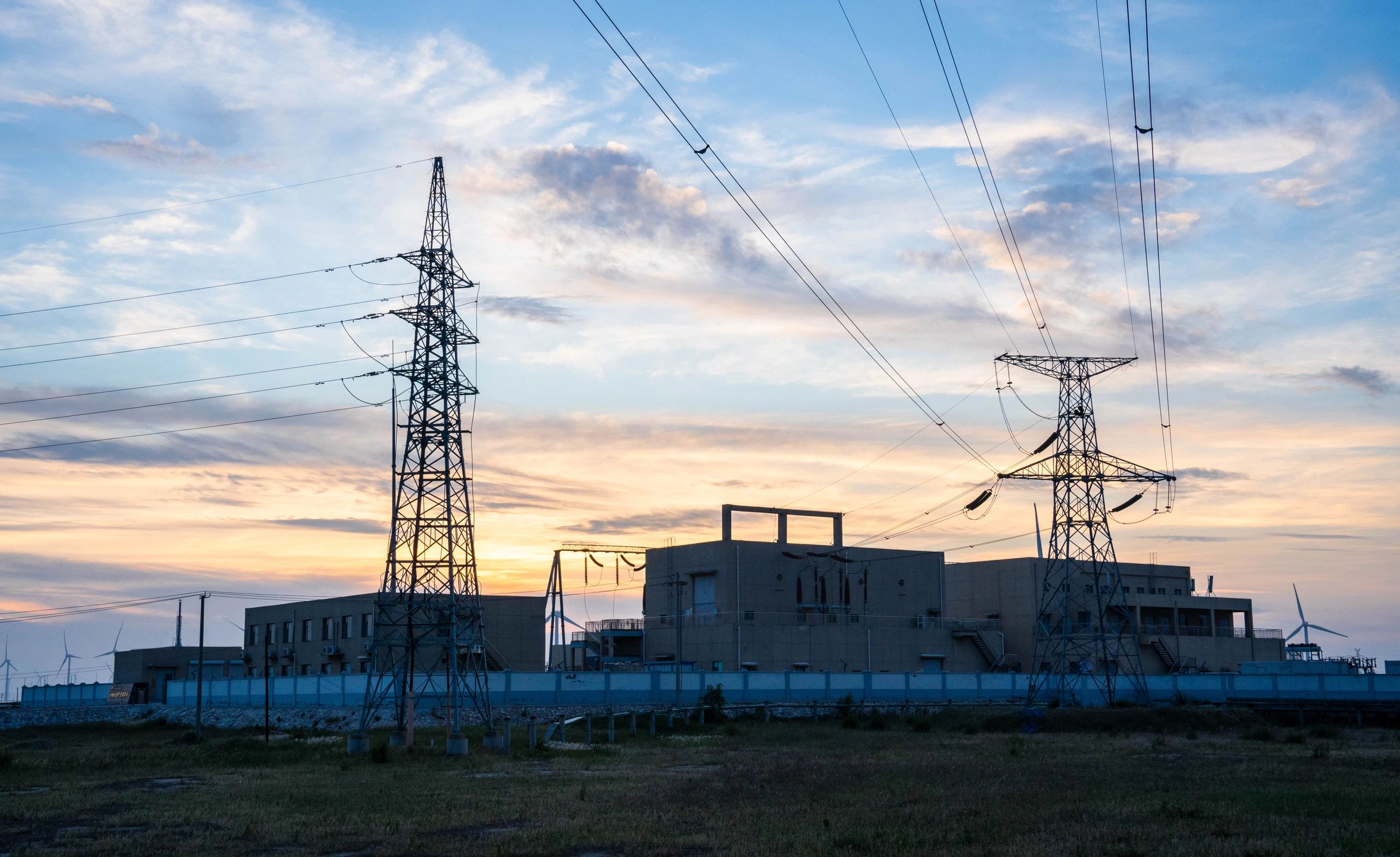 Electrical substation and transmission infrastructure at dusk